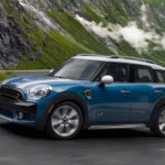 Blue MINI Cooper driving up a mountain