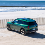 Green 2026 MINI Countryman parked near a beach