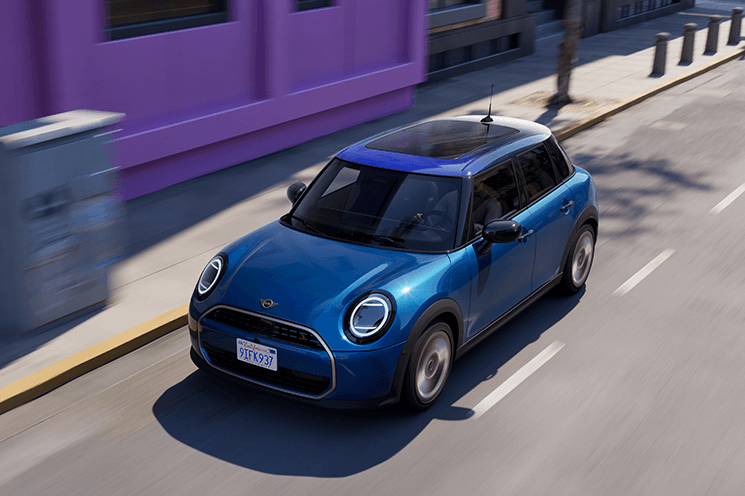 Blue MINI Cooper 4 Door driving through a city